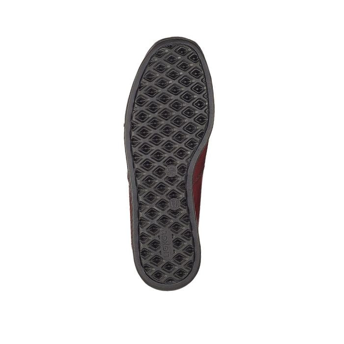Black treaded outsole of red ankle boot.