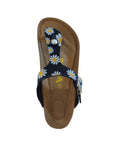 Top view of black daisy print thong style sandal with adjustable buckle strap. Yellow Viking logo in center of brown footbed.