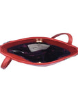 Open view of Anuschka's red leather handbag showing purple lining.