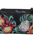Black leather handbag with vibrant floral pattern. 
