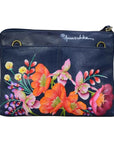 Navy leather bag with vibrant floral hand painted pattern. Anuschka signature is signed in silver on the back.