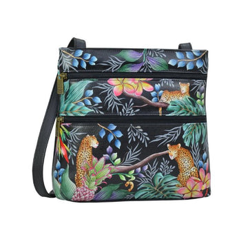 Black leather crossbody bag with two horizontal zippers. It has a hand painted jungle scene with three leopards. 
