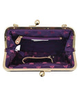 Open view of Anuschka satchel showing purple lining, zippered pocket and slip pocket.
