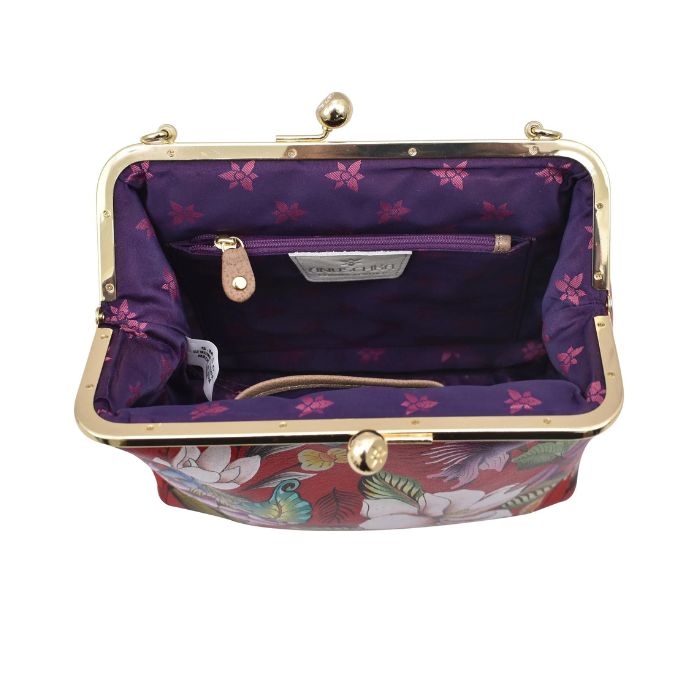 Open view of Anuschka satchel showing purple lining, zippered pocket and slip pocket.