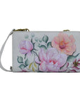 Grey leather wallet with bronze hardware and a removable crossbody strap. Hand painted floral design. 