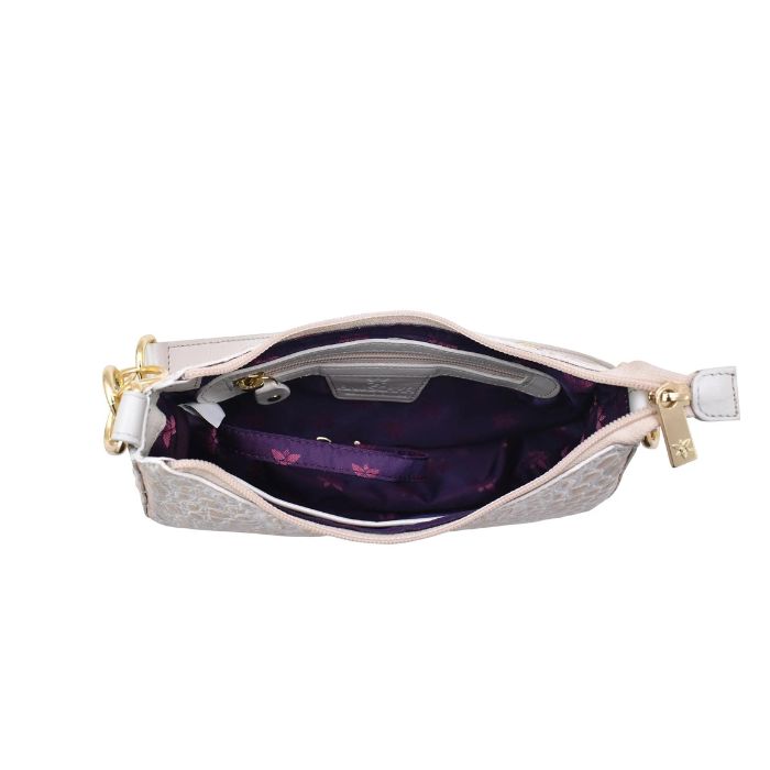 Inside view of Anuschka half moon handbag with purple lining and a zippered pocket.