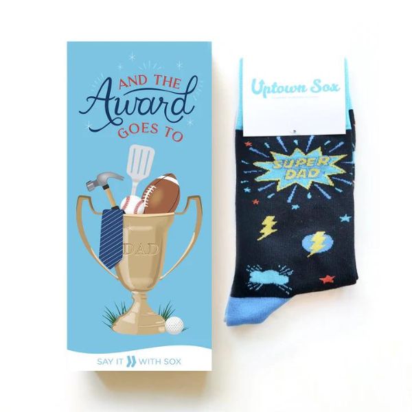 Blue card which has trophy filled with hammer, tie, baseball, football, and golf ball with text saying, "And the award goes to dad" Blue socks with stars and lightning bolts with "Super Dad" text.