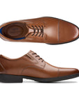Top and side view of brown leather dress shoe with laces and a toe cap.  Clarks logo printed on heel padding of insole.