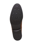 Black rubber outsole with circle pattern and Clarks logo on center.