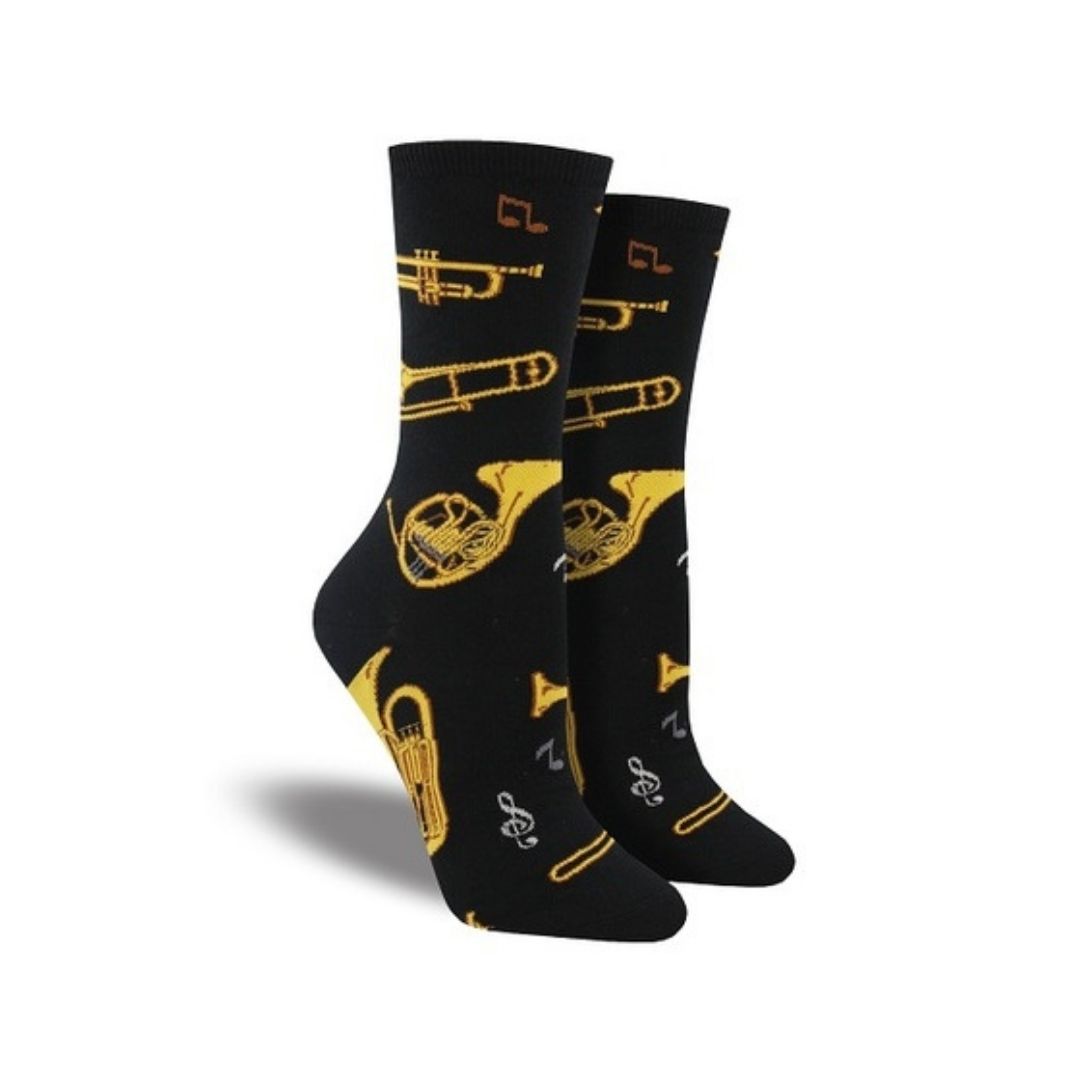 Women's Socksmith Brass cotton crew socks featuring yellow brass instruments like trumpets and French horns on a black background. Ideal for music lovers.