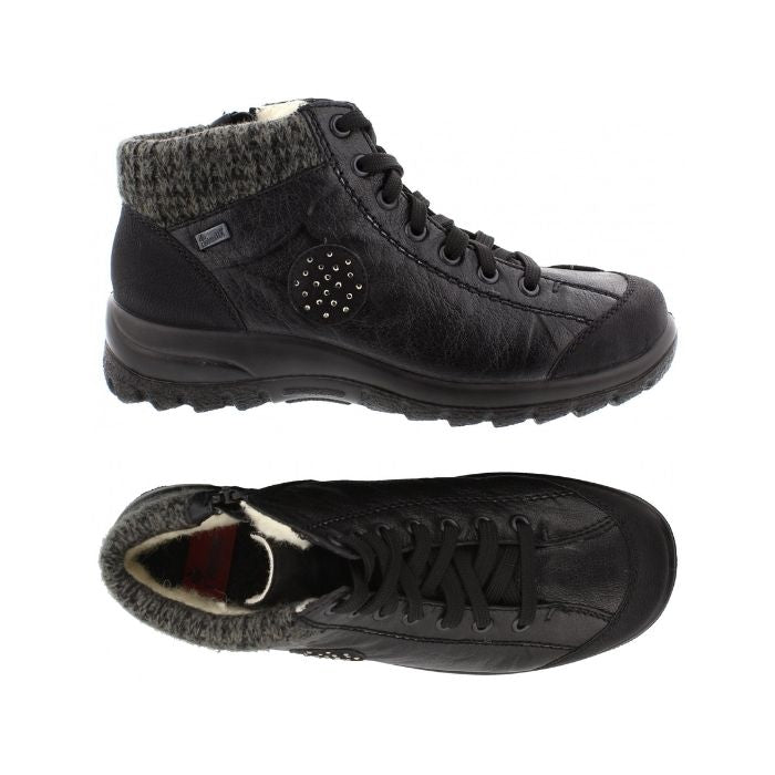Top and side view has warm lining on  Black lace up ankle boot by Rieker with knit trim and black circle accent on side with dots.